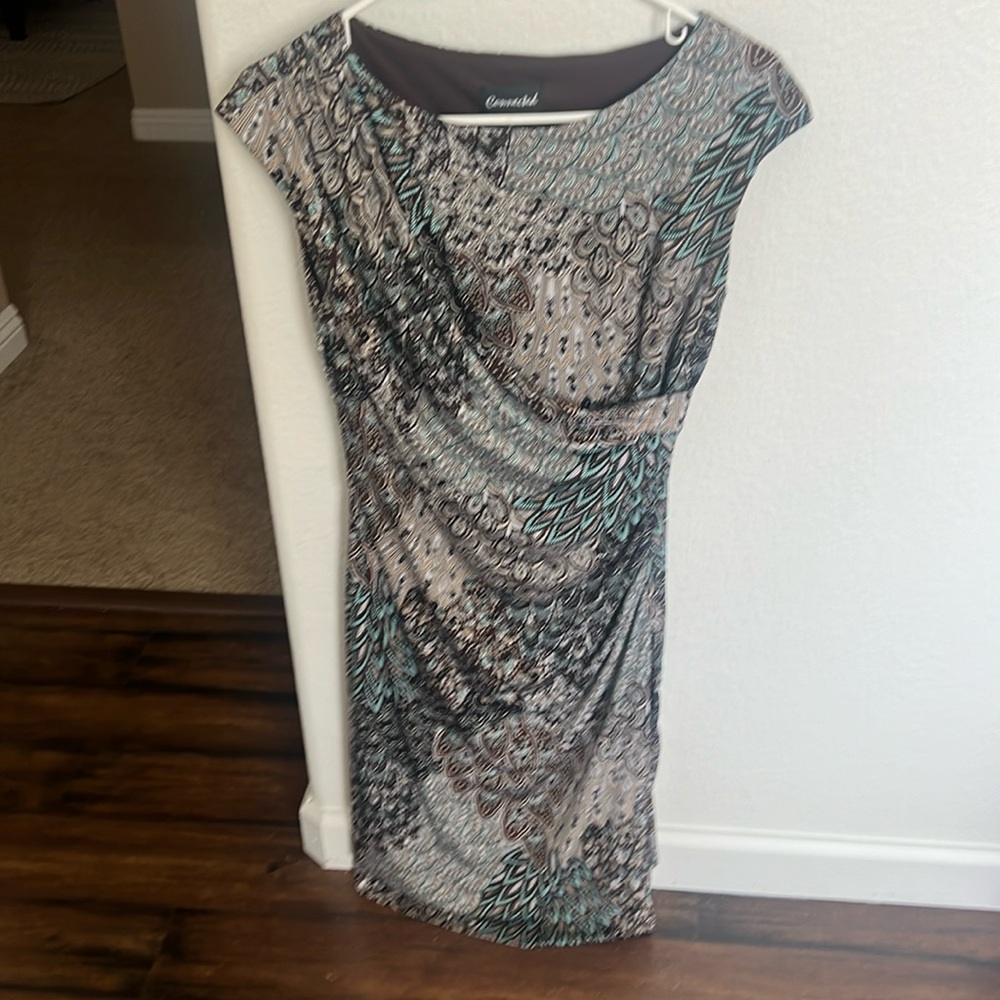 Beautifully fitting dress with drape front.